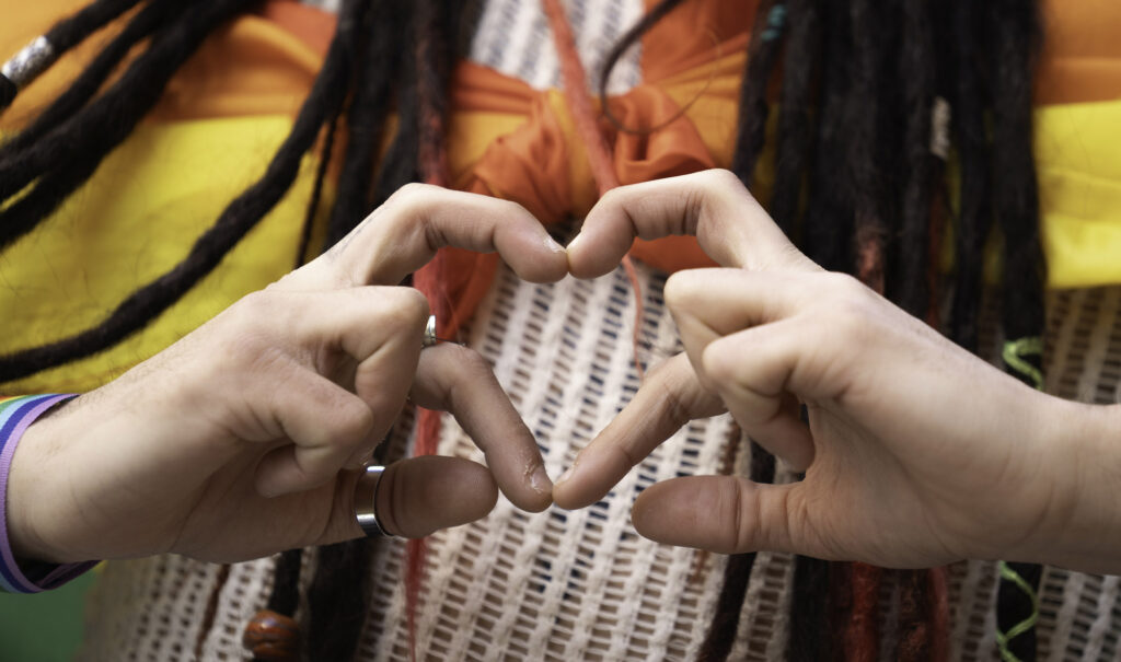 hands making heart shape with rainbow flag and dre 2026 01 08 08 15 21 utc